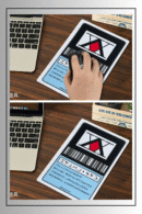 Hunter x Hunter anime mouse pad being used on a wooden desktop with a laptop