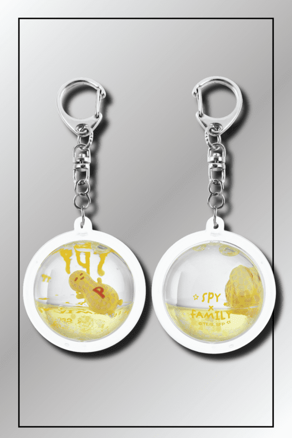 SPY x FAMILY dome keychain showing yellow back side with series logo