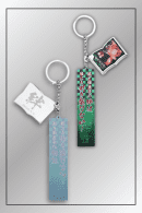 Dual-sided Demon Slayer quote keychain featuring Tanjiro and Nezuko Kamado portrait charm with green and white tags