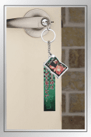 Tanjiro and Nezuko Kamado quote keychain from Demon Slayer hanging on a door handle with sibling photo charm